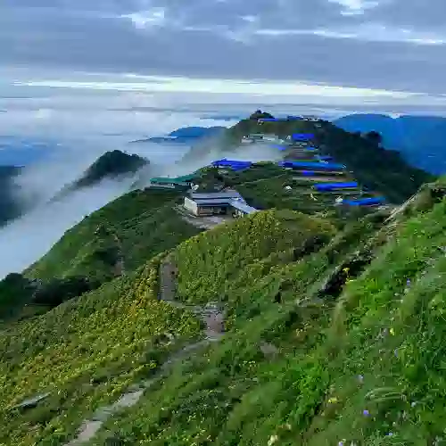 Blue-roof lodges on a ridge above the clouds, Mardi Himal